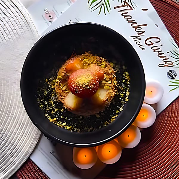 Amrut Fusion dessert with gulab jamun, pistachios, and edible glitter, next to a Thanksgiving menu.